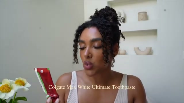 @angela.onuoha reviewing Colgate Max White Ultimate Toothpaste at 16:23 in a YouTube Shorts video
