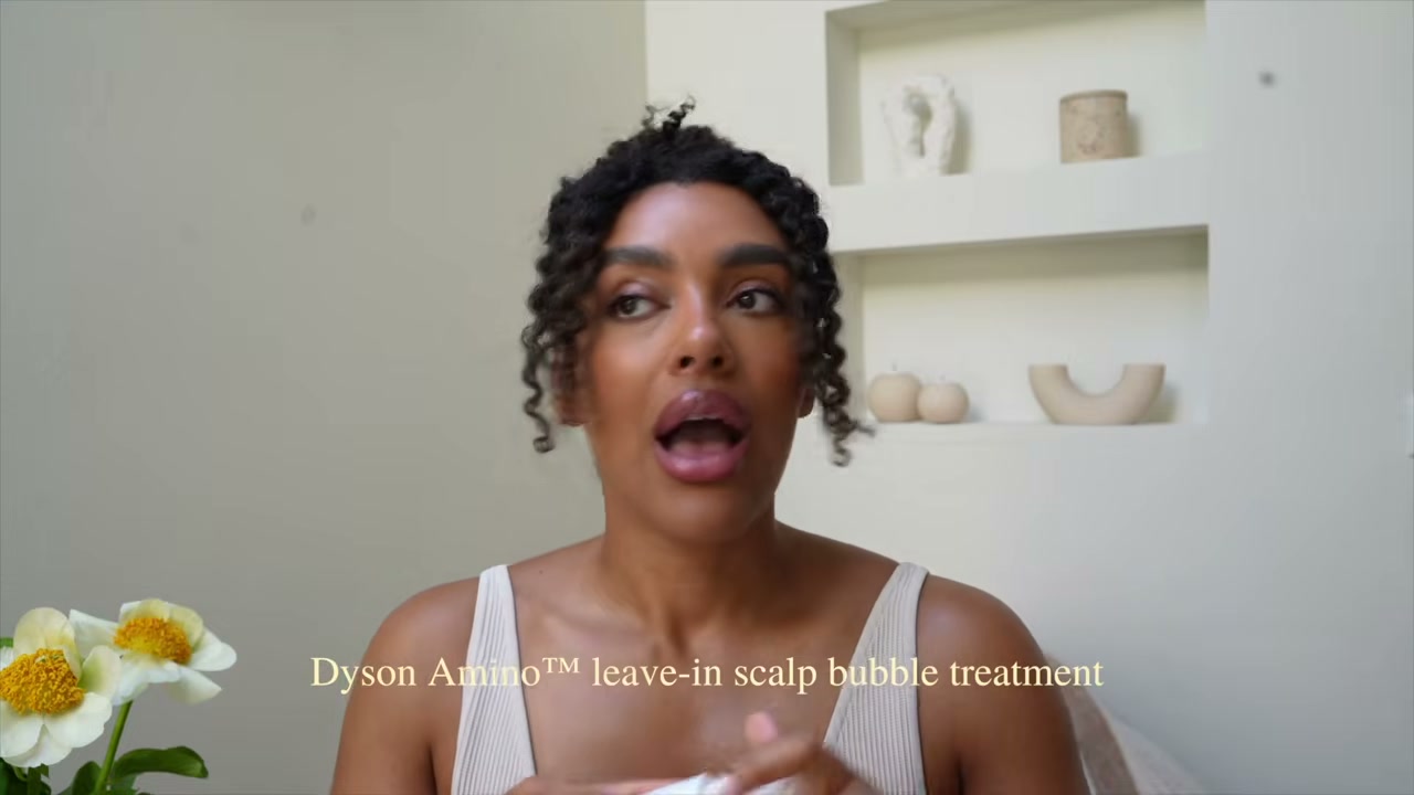 @angela.onuoha reviewing Dyson Amino Leave-in Scalp Bubble Treatment at 15:02 in a YouTube Shorts video