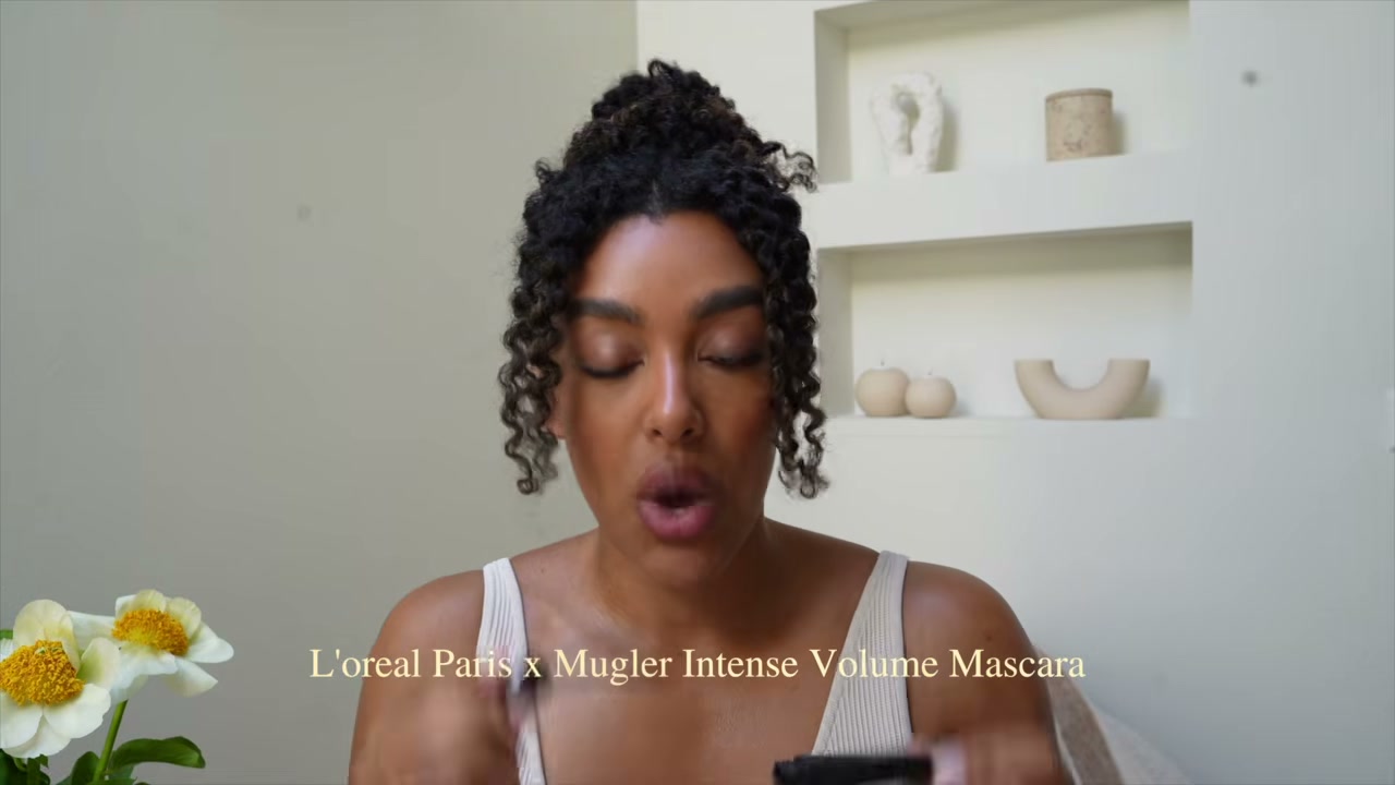 @angela.onuoha reviewing L'Oreal Paris X Mugler Intense Volume Mascara at 18:17 in a YouTube Shorts video