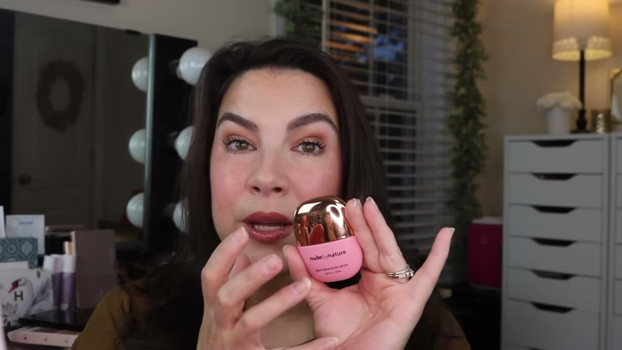 @emilynoel83 reviewing Nude by Nature Dewy Serum Blush Drops at 18:57 in a YouTube Shorts video