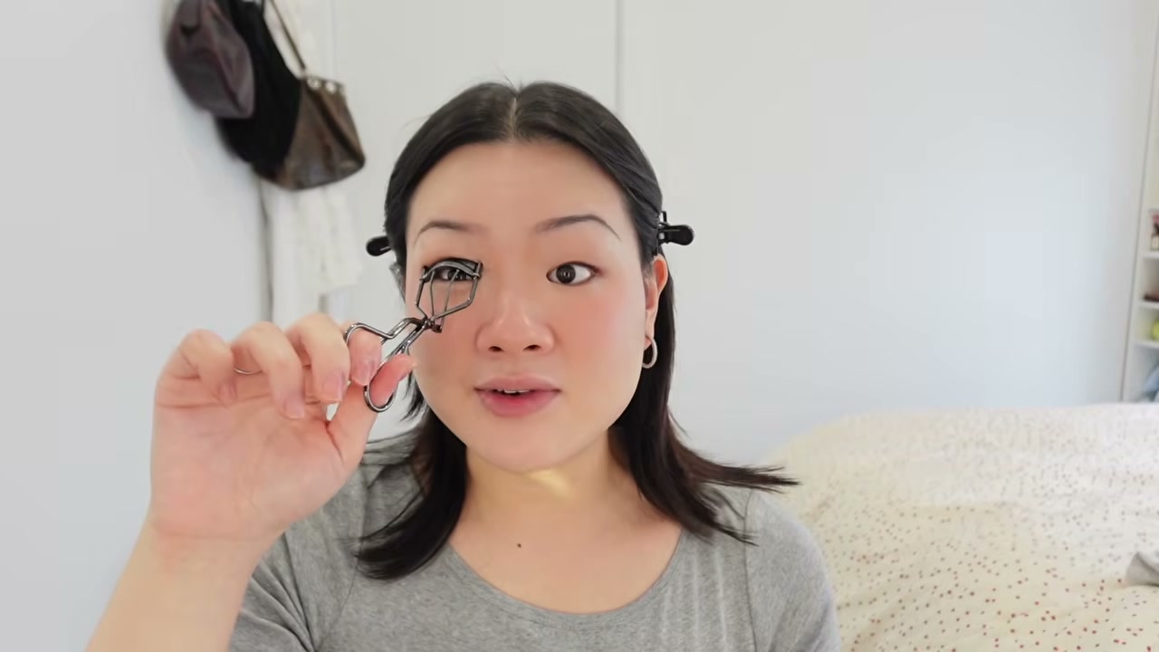 @estherdaze reviewing Shiseido Eyelash Curler at 04:16 in a YouTube Shorts video