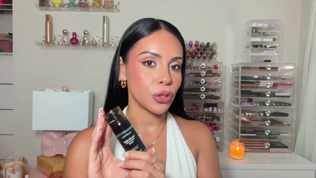 @juicyjas reviewing Catrice Aqua Splash Grip Fixing Spray at 24:08 in a YouTube Shorts video