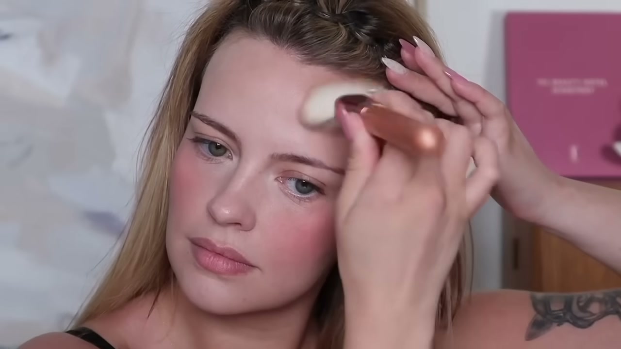 @juliaadamsmua reviewing Marc Jacobs Beauty Legally Bronze Powder Bronzer at 09:03 in a YouTube Shorts video