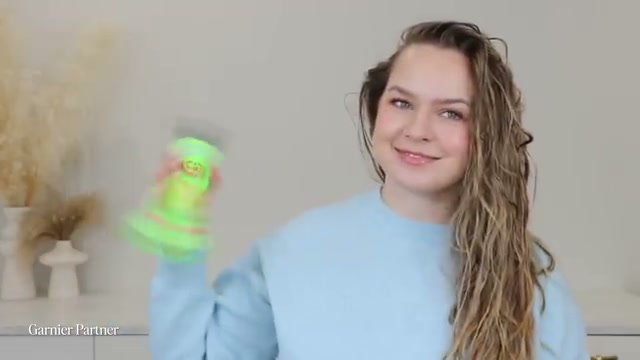 @kayleymelissa reviewing Garnier Fructis Sleek & Shine 10-in-1 Multitasking Leave-in at 01:19 in a YouTube Shorts video