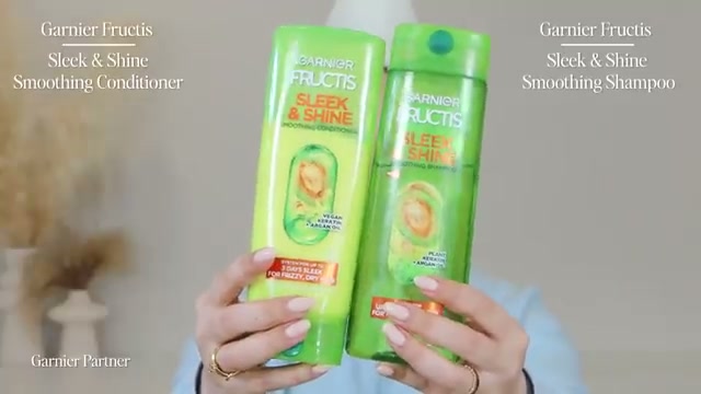 @kayleymelissa reviewing Garnier Fructis Sleek & Shine Smoothing Shampoo at 01:03 in a YouTube Shorts video