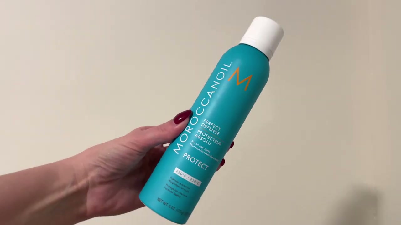 @laura.lavigne reviewing Moroccanoil Perfect Defense Heat Protectant at 06:37 in a YouTube Shorts video