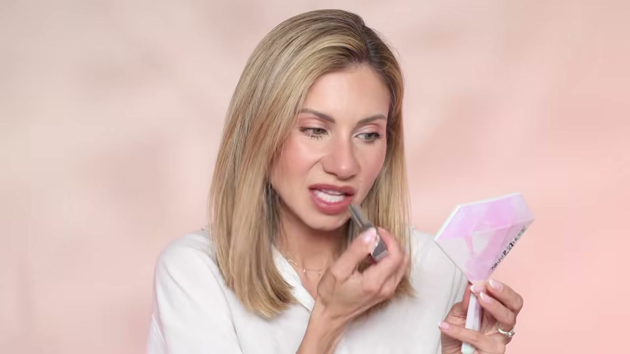 @lisajmakeup reviewing e.l.f. Cosmetics Glow Reviver Lip Oil Stick at 20:11 in a YouTube Shorts video