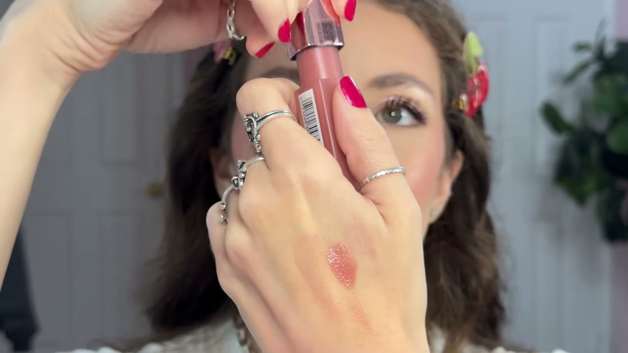 @moorebeautifully reviewing L'Oreal Paris Hyaluron Tint Lip Stain Serum at 60:35 in a YouTube Shorts video