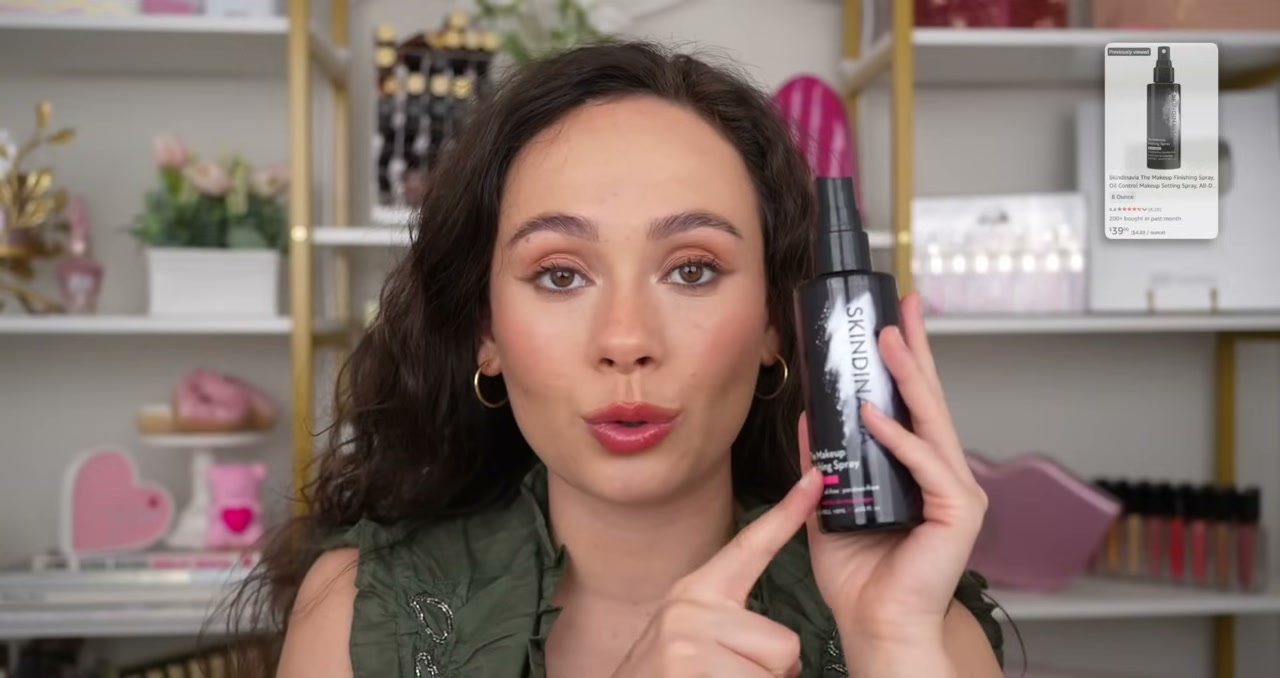 @morganturnermakeup reviewing Skindinavia The Makeup Finishing Spray at 25:41 in a YouTube Shorts video