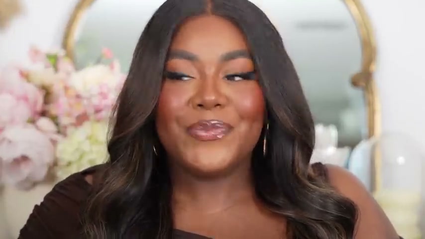 @musingsofacurvylady reviewing Fenty Beauty Hot Chocolate Lip Gloss at 04:30 in a YouTube Shorts video
