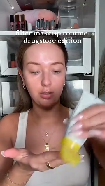 @shelbyannbell reviewing e.l.f. Cosmetics Suntouchable Whoa Glow Broad Spectrum SPF 30 Sunscreen at 01:17 in a YouTube Shorts video