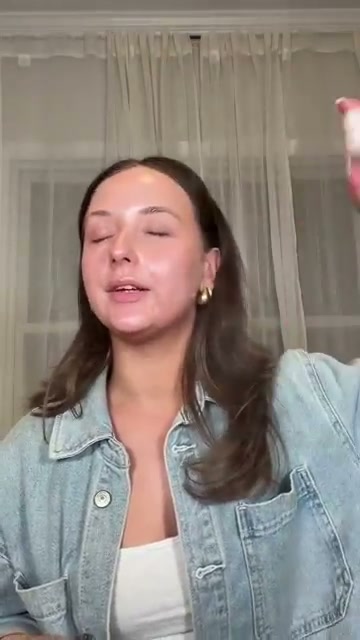 @shelbyannbell reviewing Kopari Beauty Sunglaze Sheer Setting Mist Sunscreen SPF 50 at 00:11 in a YouTube Shorts video