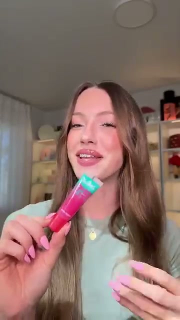 @skylerreneee reviewing Essence Juicy Bomb Glossy Butter Balm at 00:05 in a YouTube Shorts video
